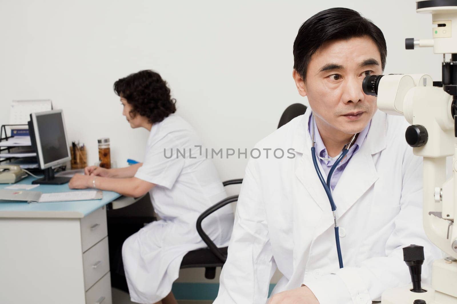 Close-up of an optometrist looking into an ophthalmoscope