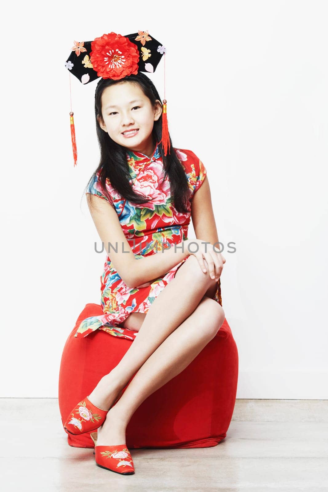 Portrait of a teenage girl sitting on a stool