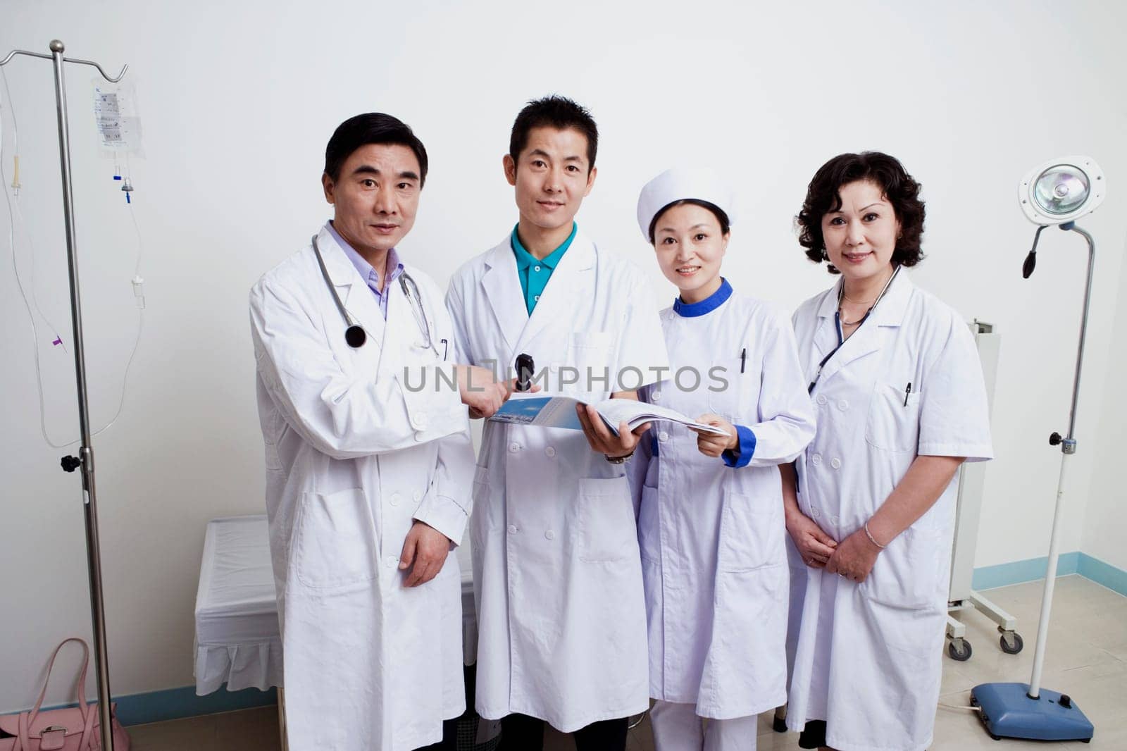Portrait of two male doctors and a female doctor with a female nurse