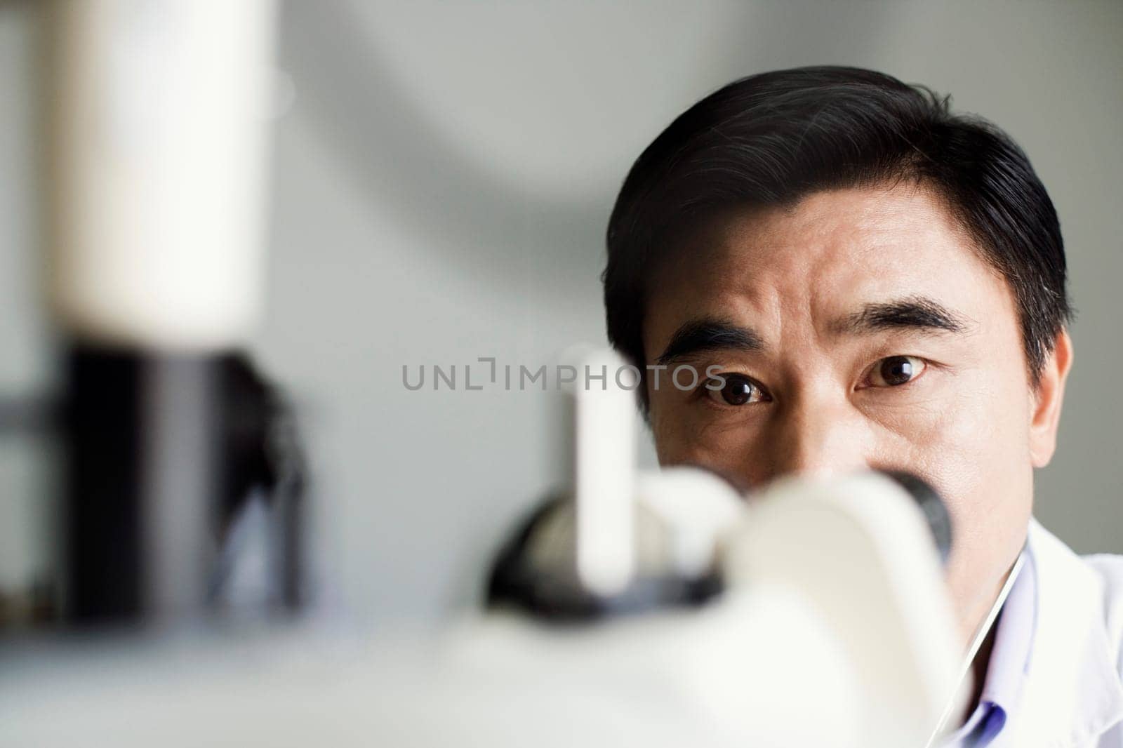 Close-up of an optometrist in front of an ophthalmoscope