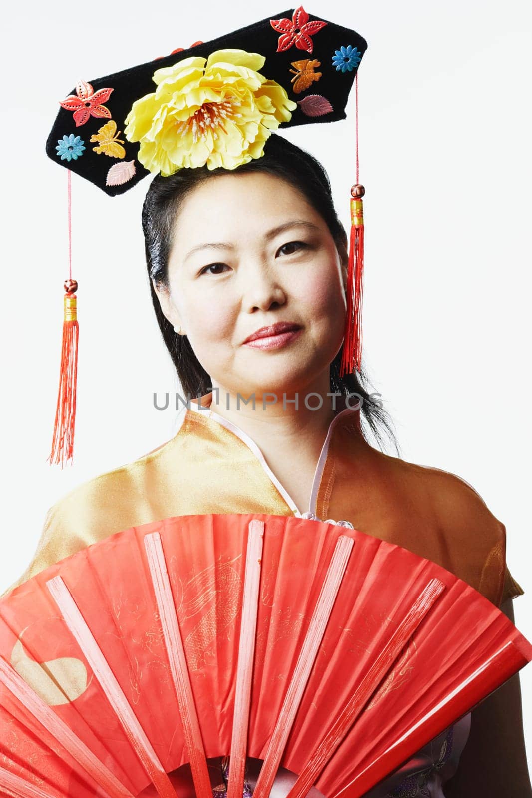 Portrait of a mid adult woman holding a folding fan