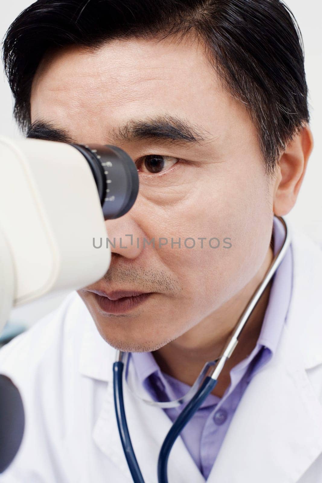 Close-up of an optometrist looking into an ophthalmoscope