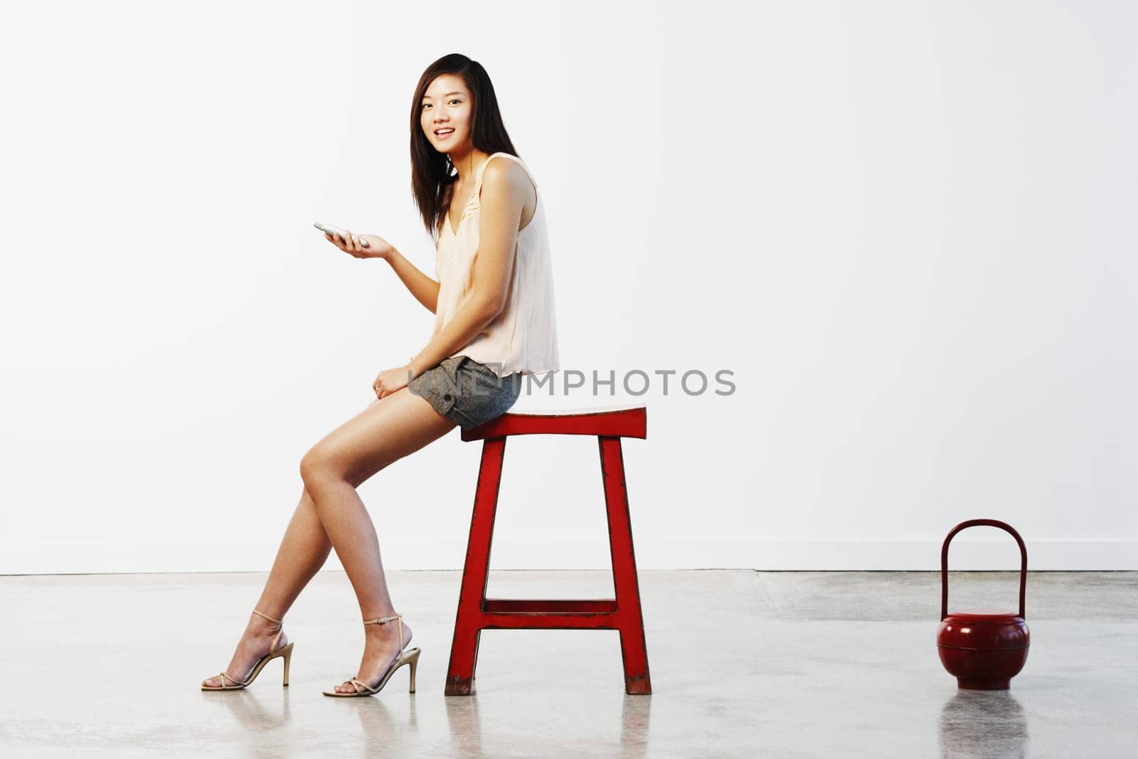 Portrait of a young woman holding a mobile phone