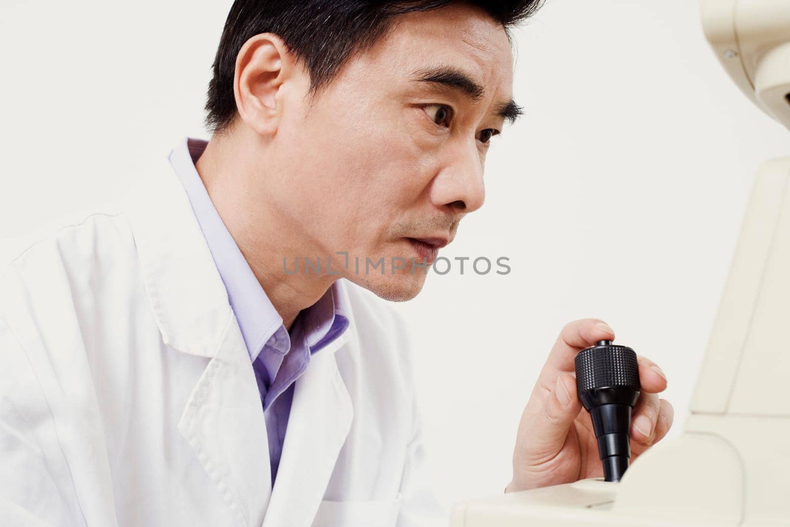 Close-up of an optometrist operating an ophthalmoscope