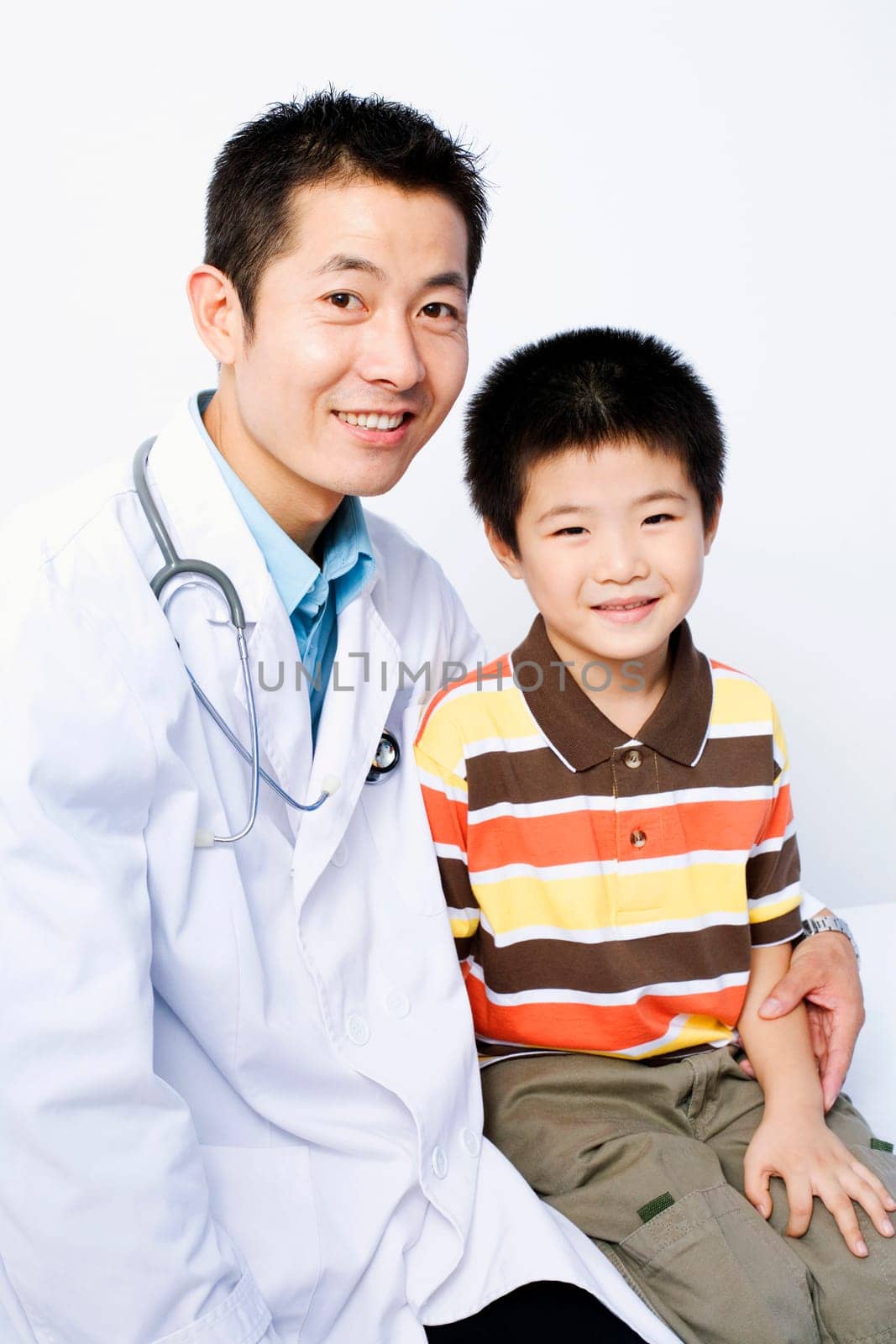 Portrait of a male doctor and a boy sitting together