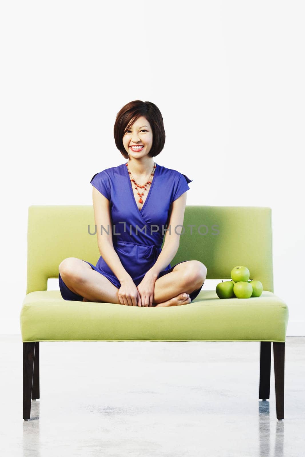 Portrait of a young woman sitting on a couch