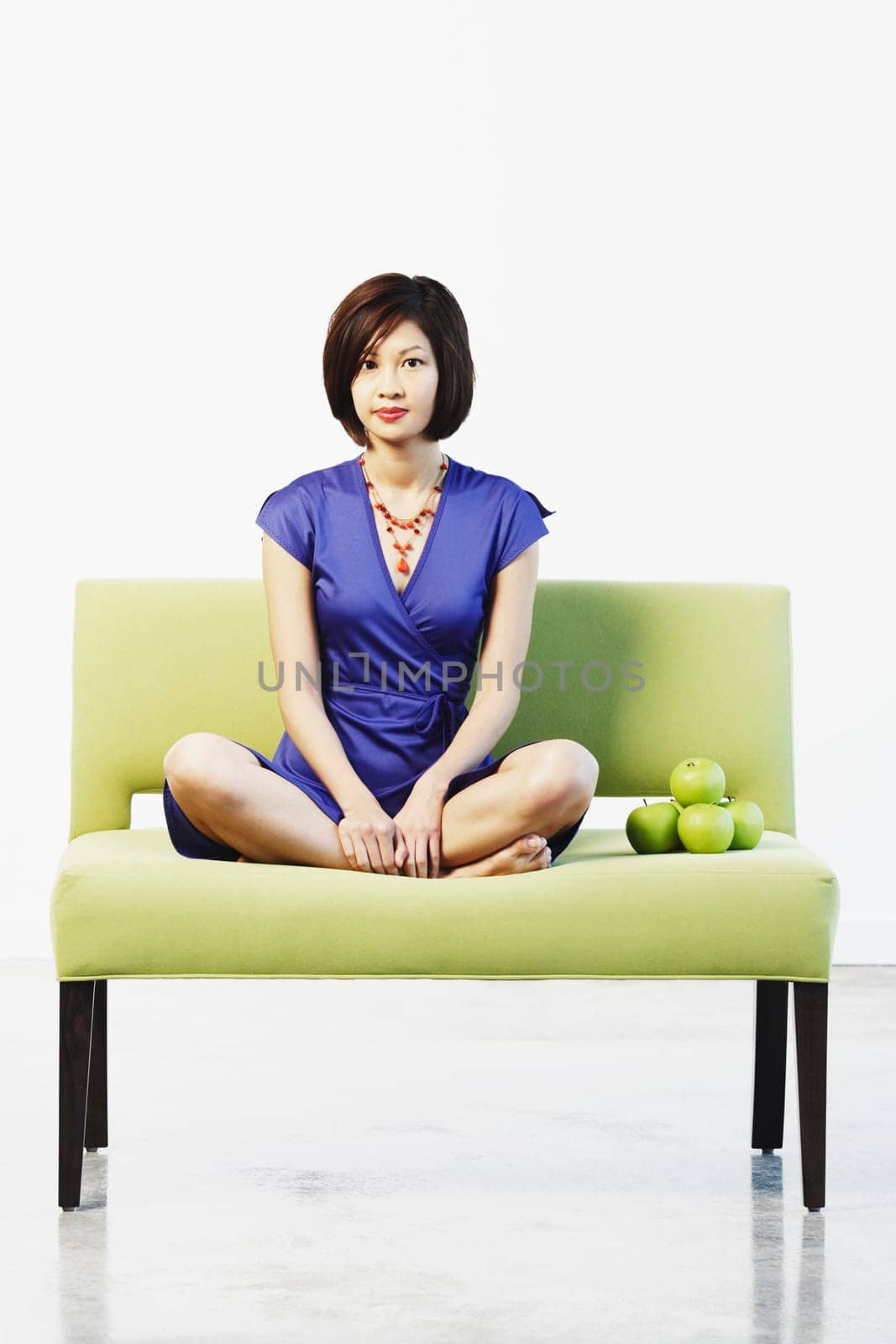 Portrait of a young woman sitting on a couch