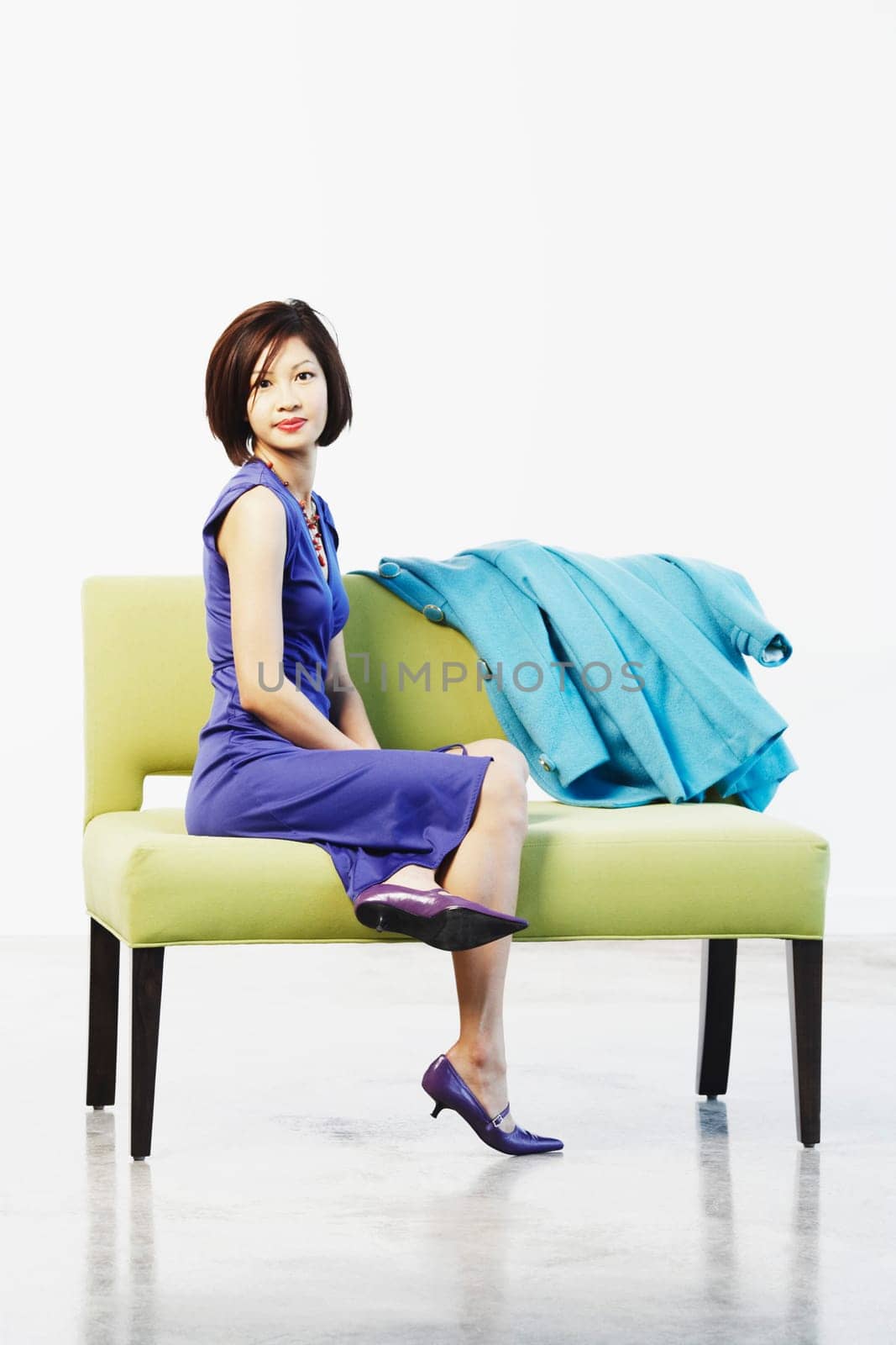 Portrait of a young woman sitting on a couch