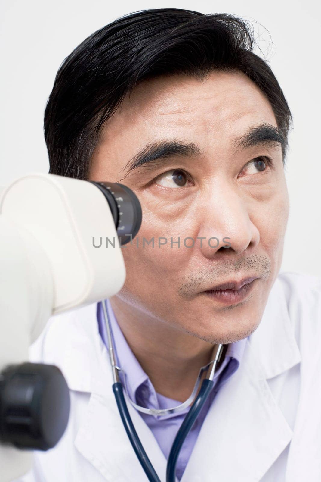 Close-up of an optometrist in front of an ophthalmoscope
