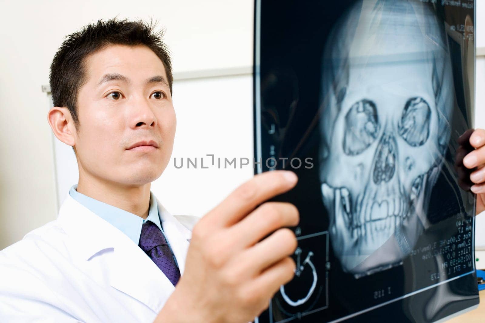 Close-up of a male doctor holding an X-Ray image