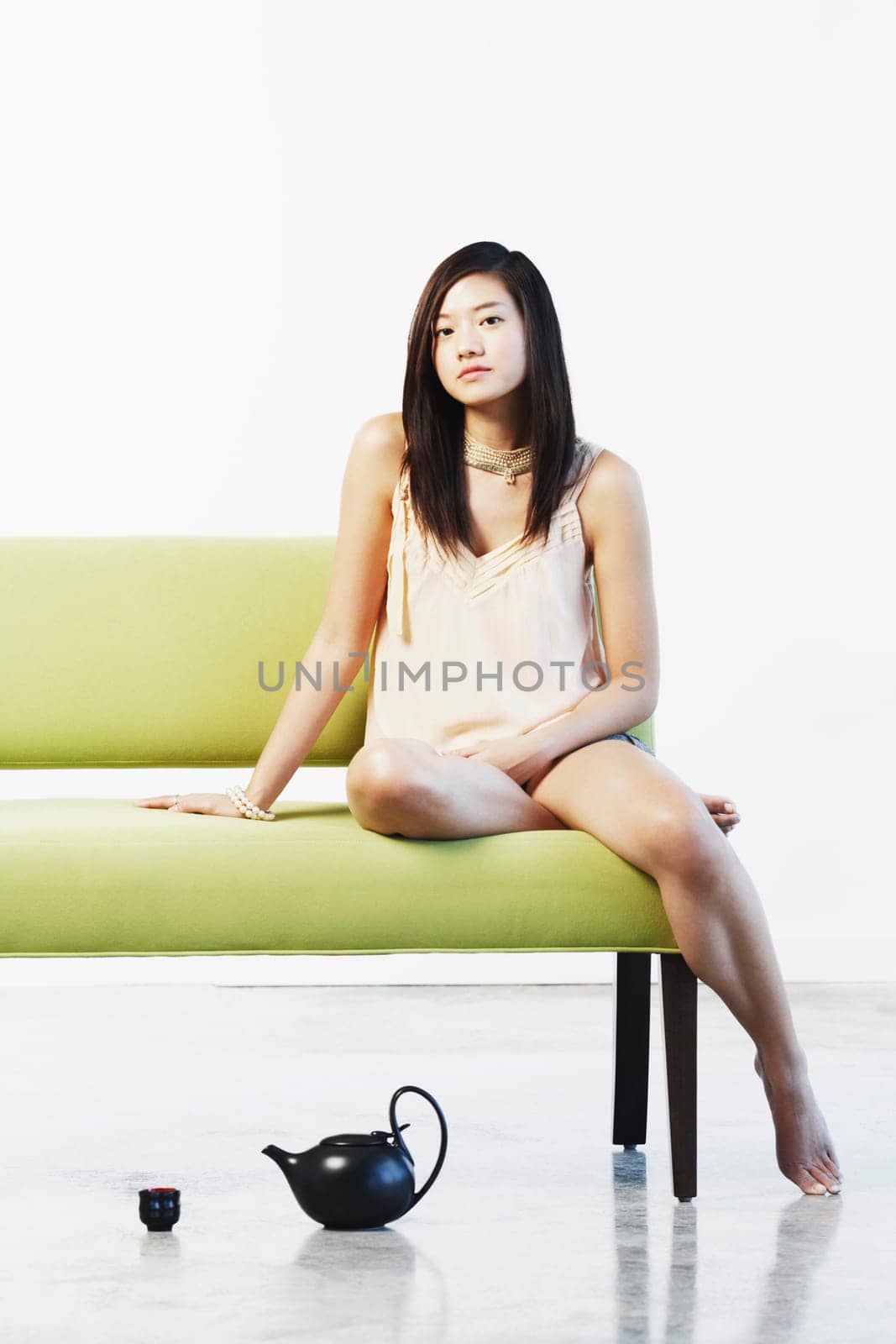 Portrait of a young woman sitting on a couch