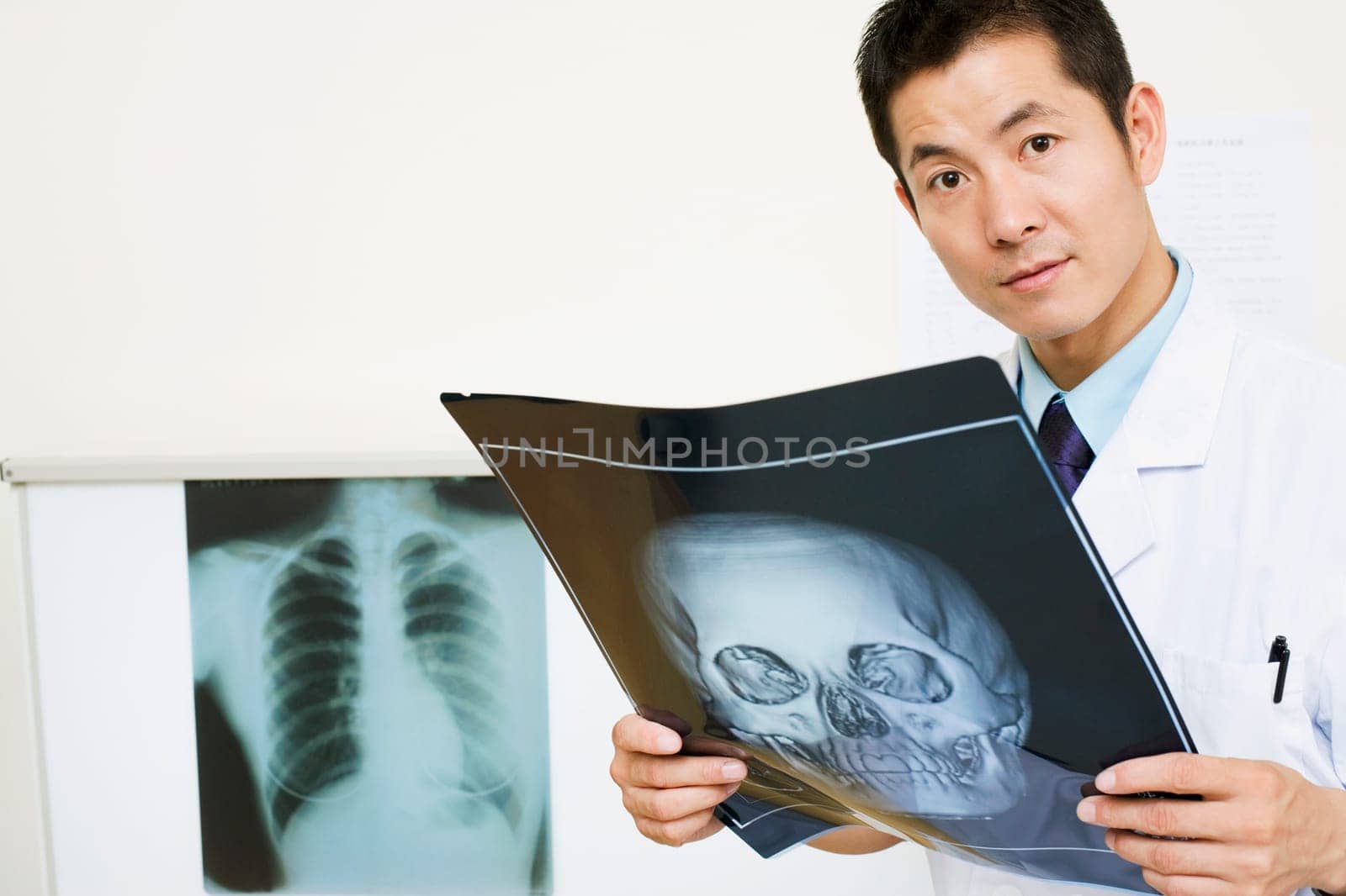 Portrait of a male doctor holding an X-Ray