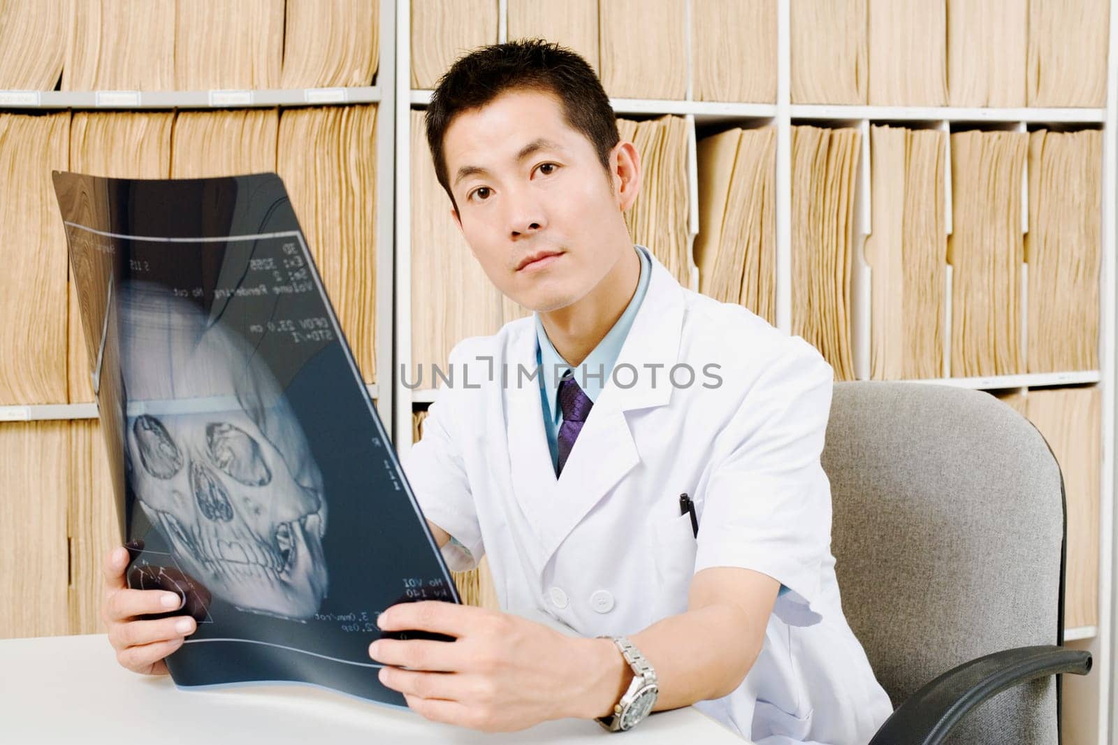 Portrait of a male doctor holding an X-Ray