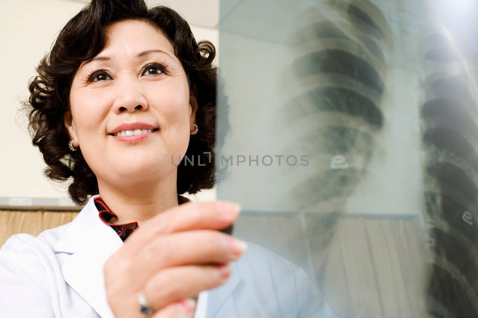 Close-up of a female doctor examining an X-Ray