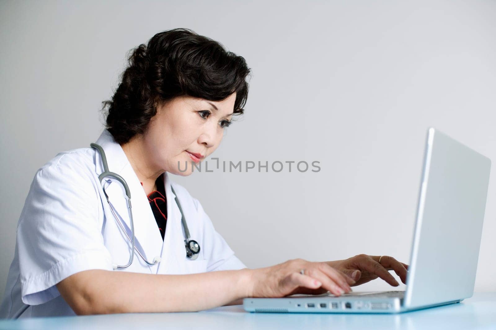Close-up of a female doctor working on a laptop