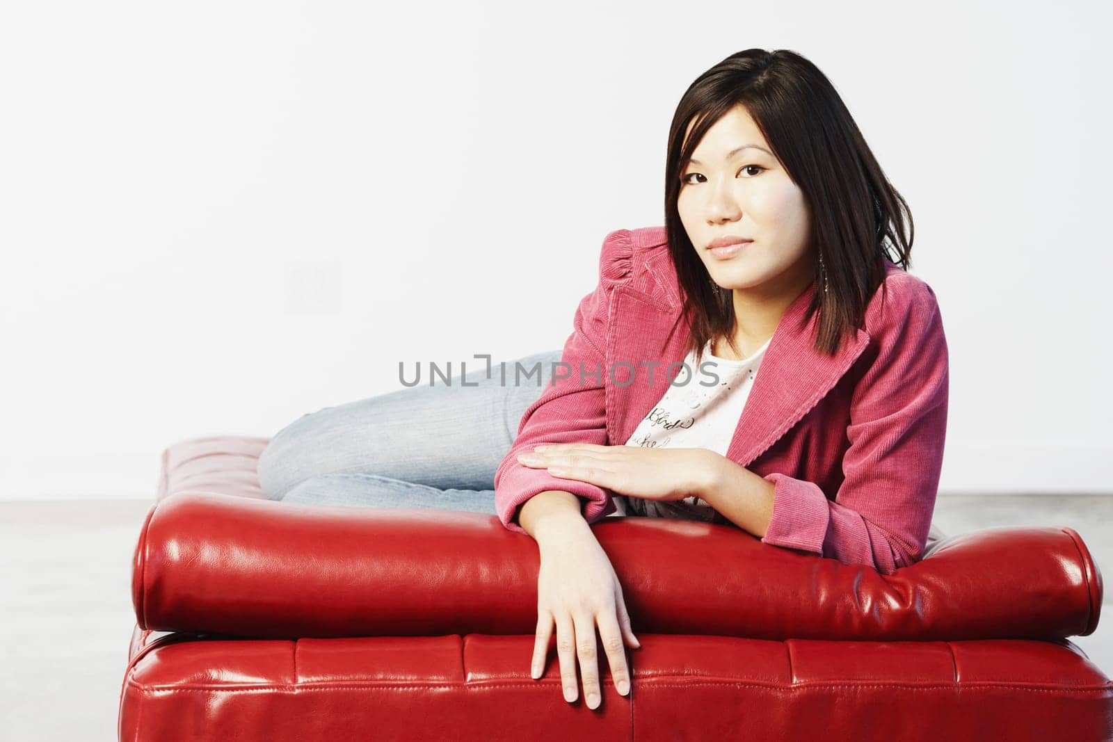 Portrait of a young woman lying down on a mattress