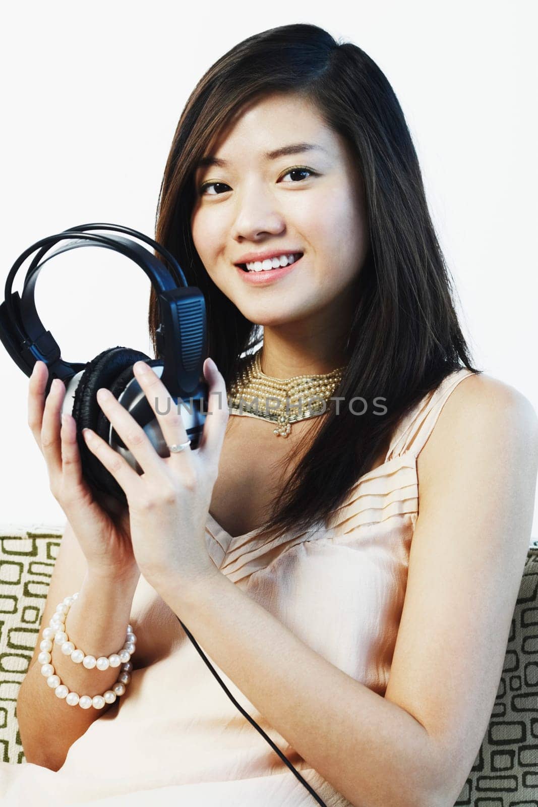 Portrait of a young woman holding headphones