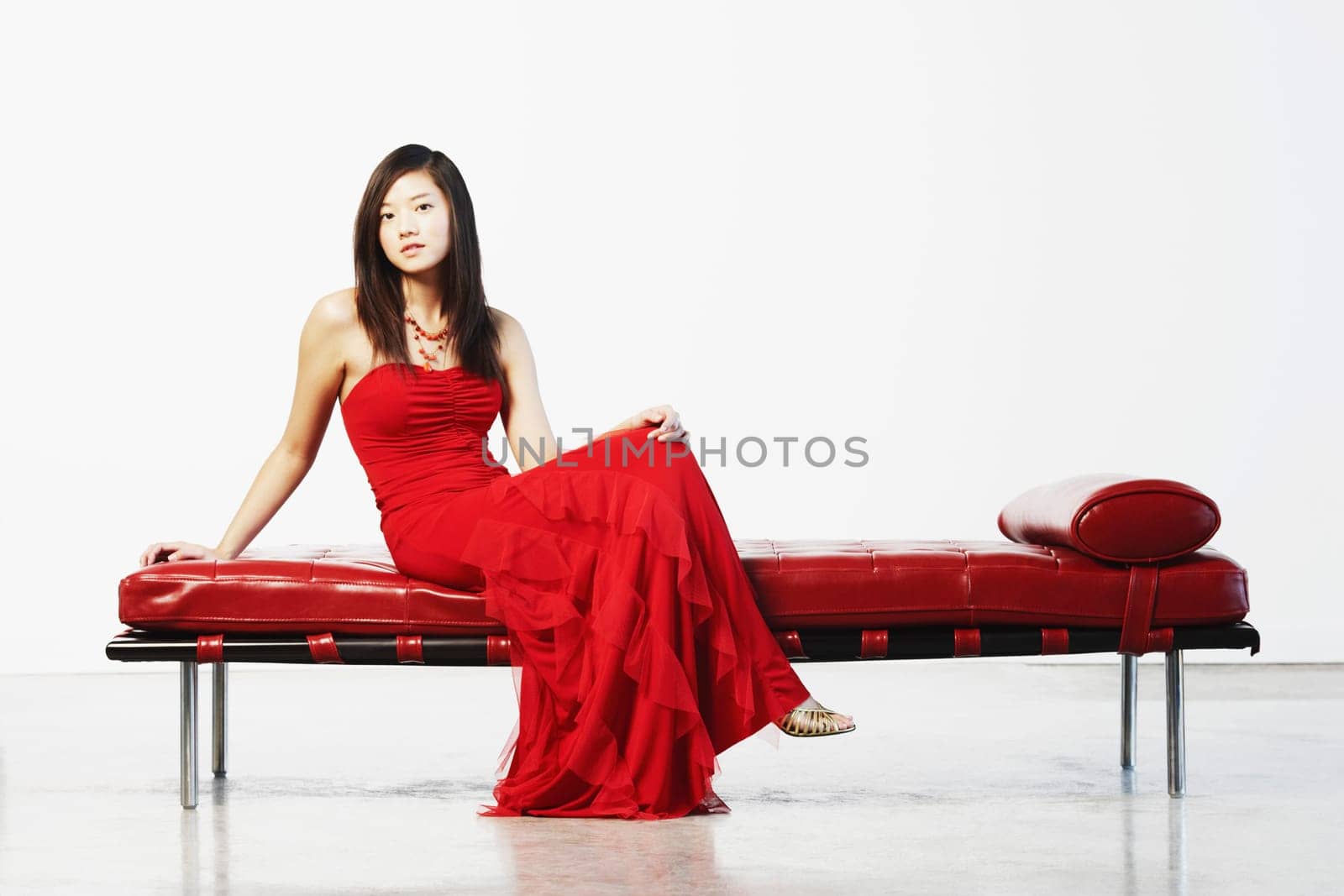Portrait of a young woman sitting with her legs crossed