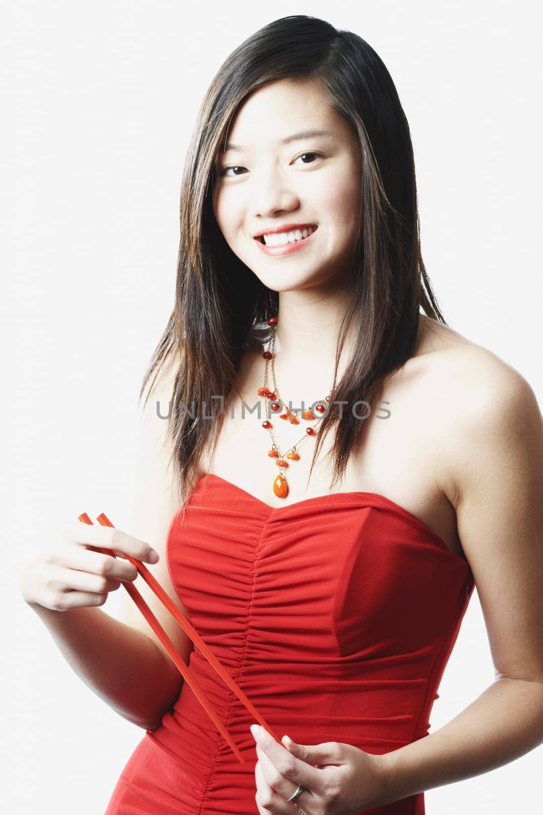 Portrait of a young woman holding chopsticks