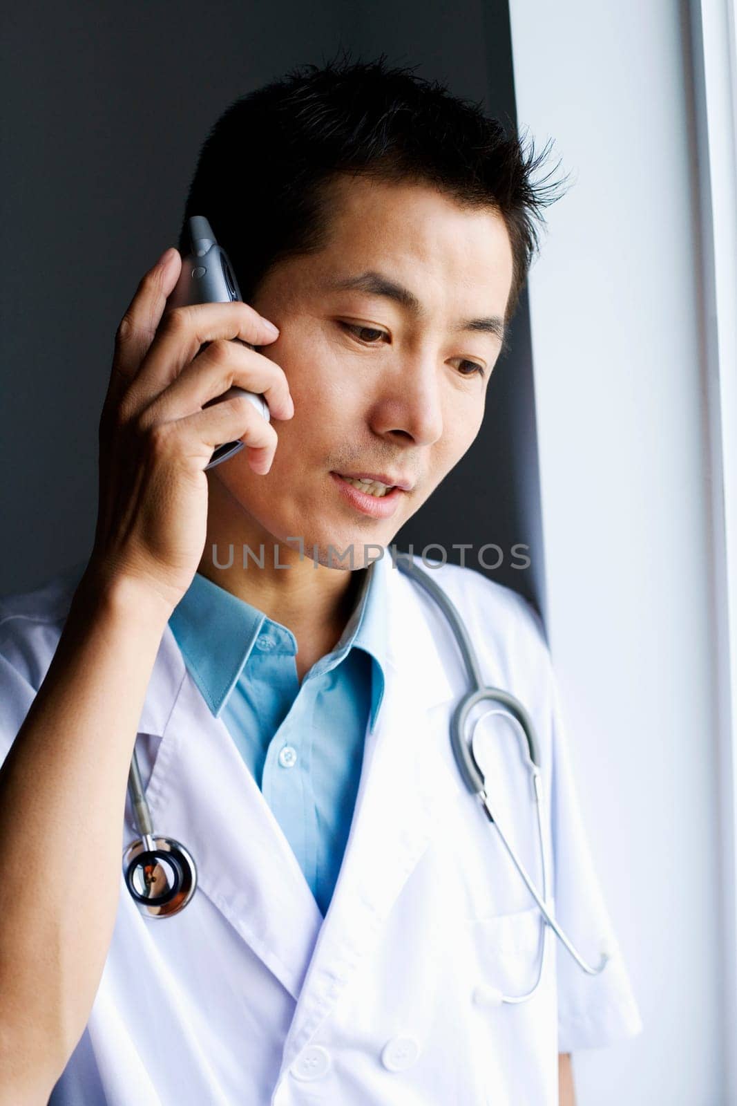 Close-up of a male doctor talking on a mobile phone