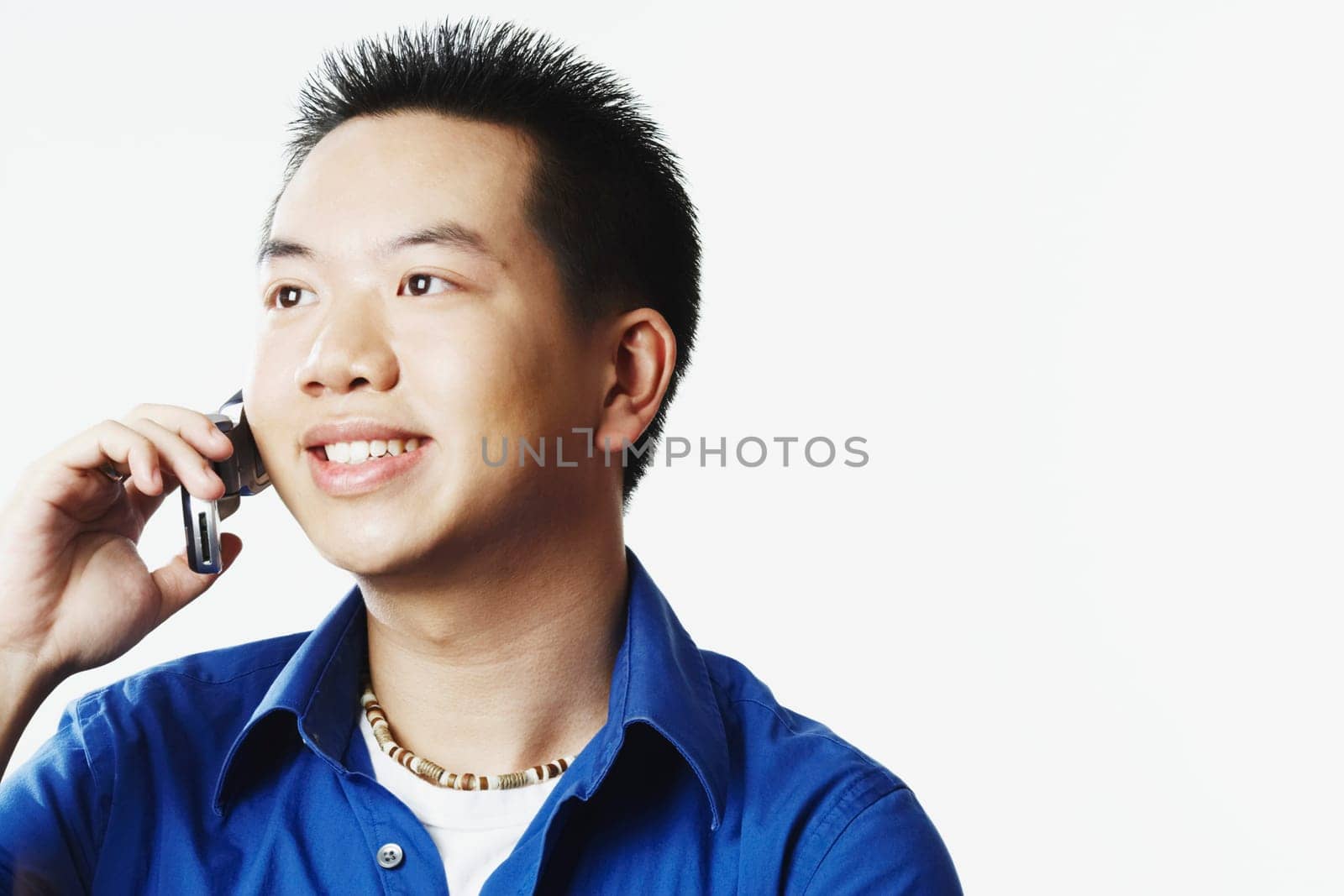Close-up of a young man talking on a mobile phone