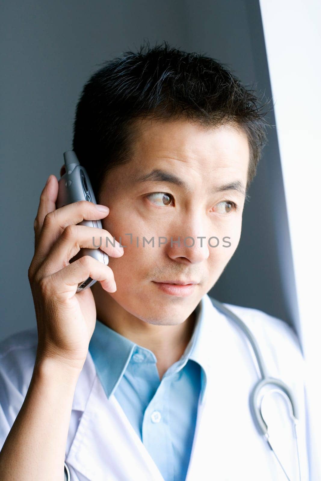 Close-up of a male doctor talking on a mobile phone