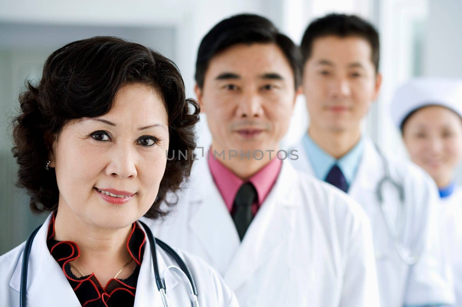 Portrait of three doctors with a nurse