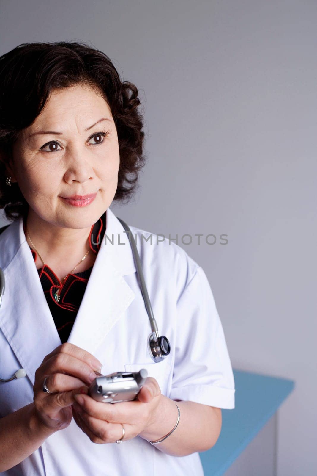 Close-up of a female doctor holding a personal data assistant