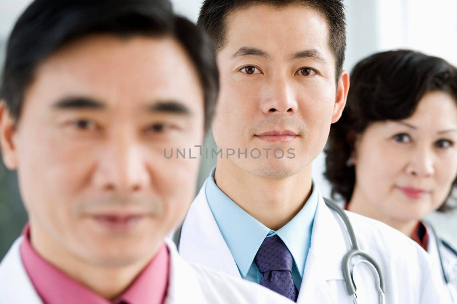 Portrait of two male doctors with a female doctor