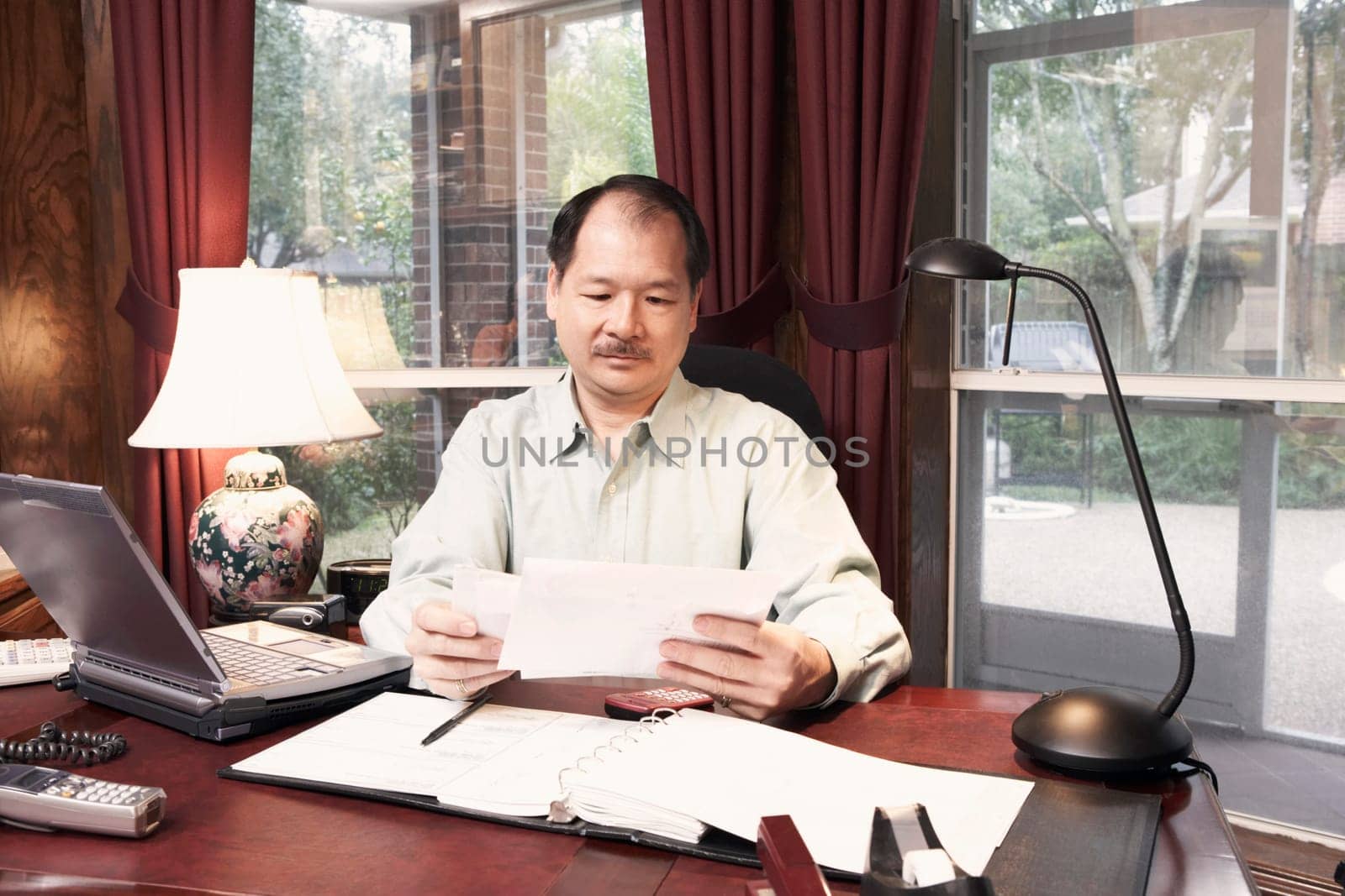 Close-up of a senior man holding a letter
