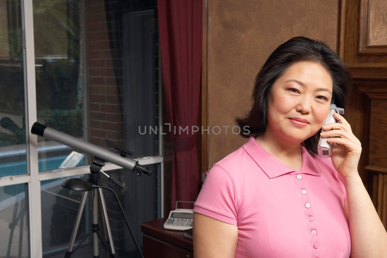 Portrait of a mature woman talking on a cordless telephone