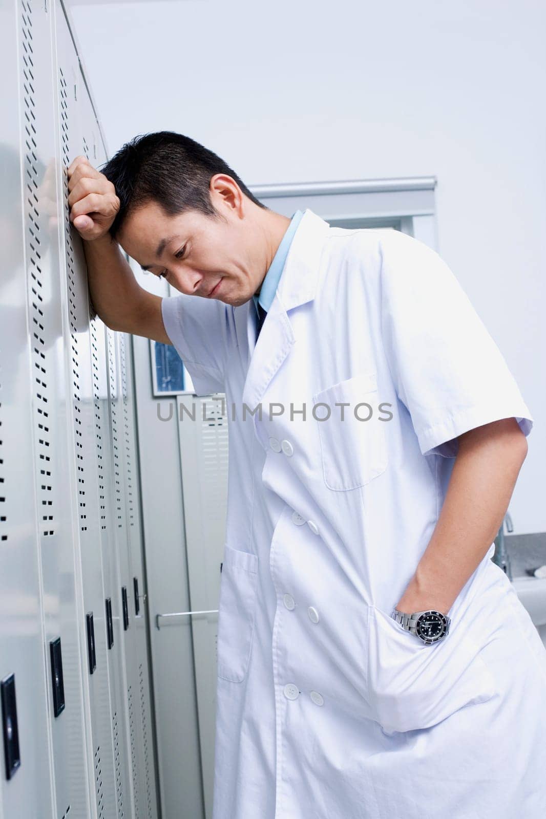 Close-up of a doctor leaning against a locker