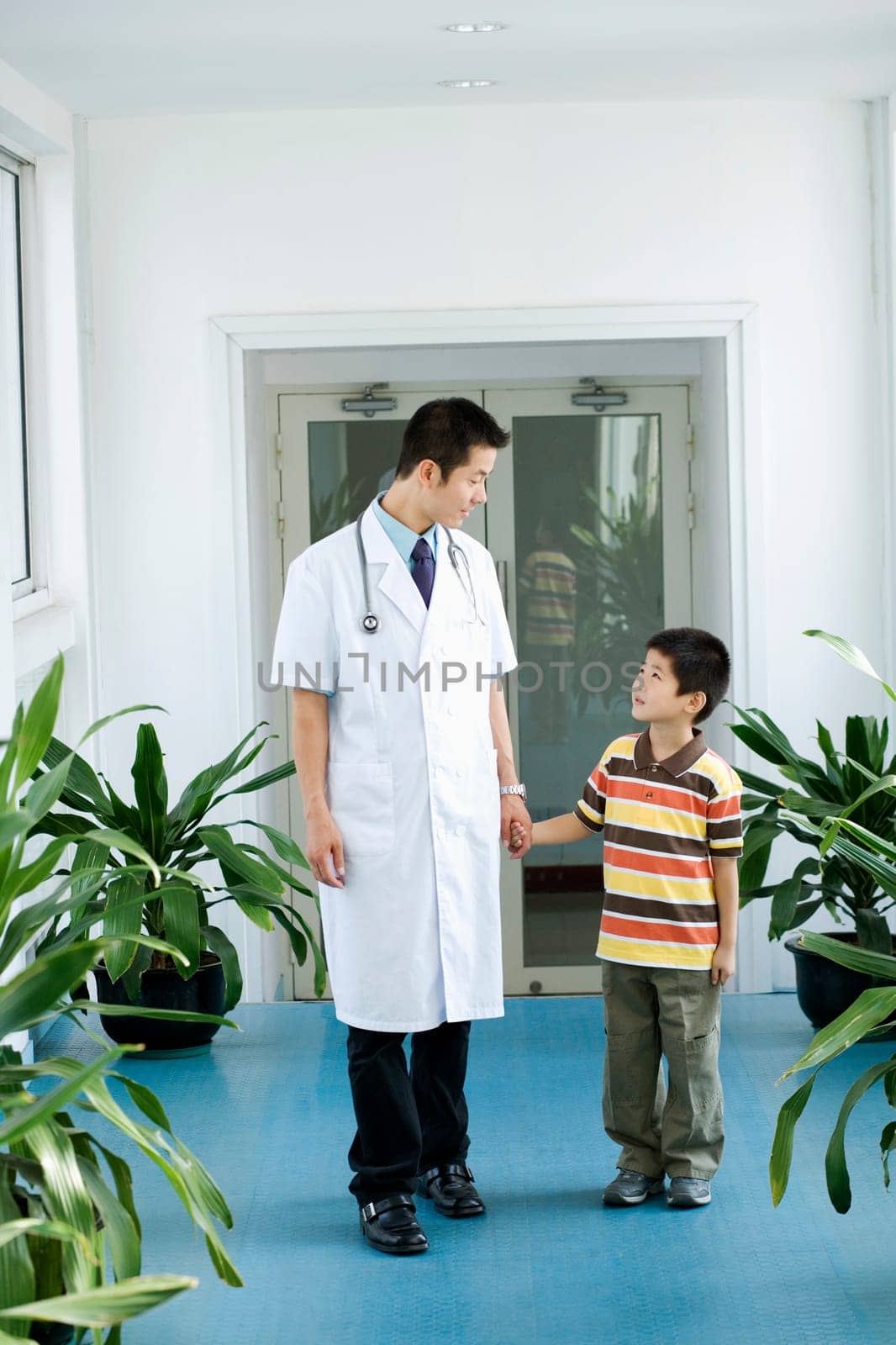 Male doctor holding a boyŽs hands