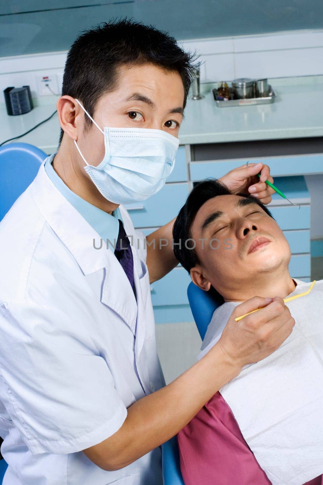 Portrait of a male doctor while examining a male patient