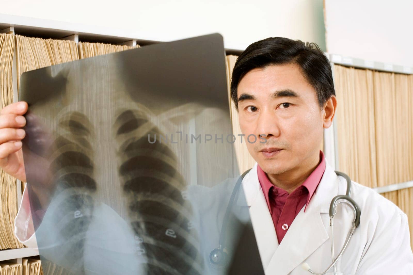 Portrait of a male doctor holding an X-Ray