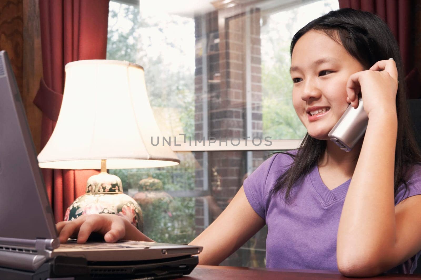 Close-up of a girl talking on a cordless telephone