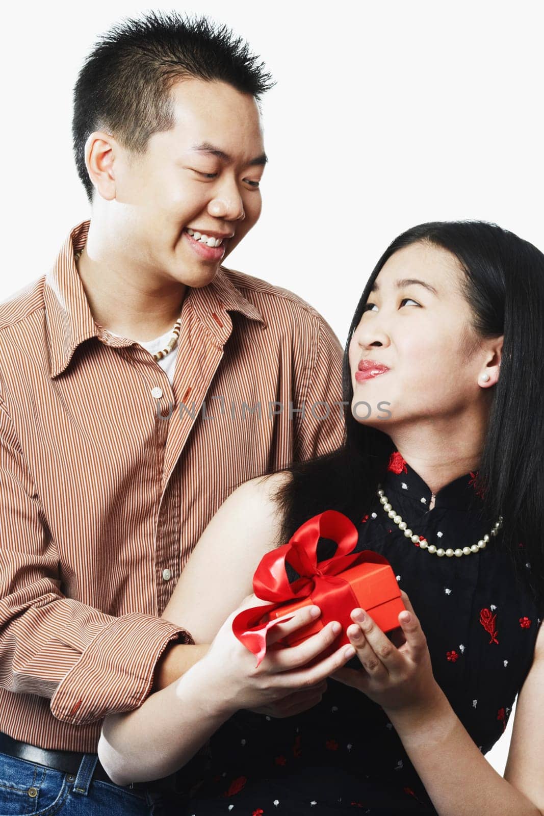Close-up of a young couple holding a gift