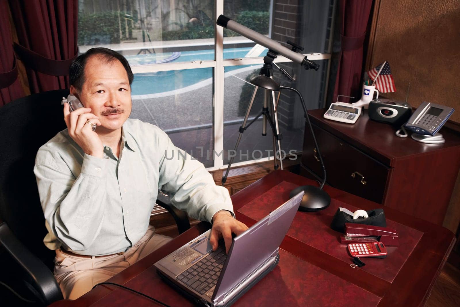High angle view of a senior man talking on a cordless telephone