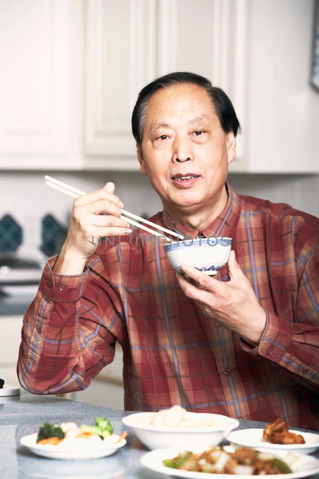 Portrait of a senior man eating food