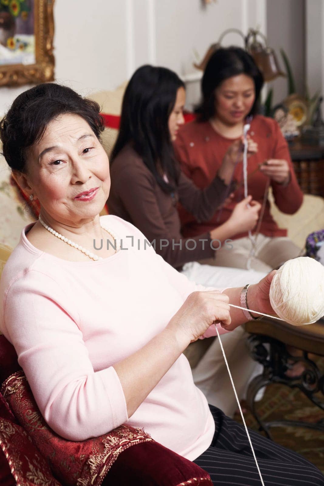 Portrait of a senior woman holding a ball of wool