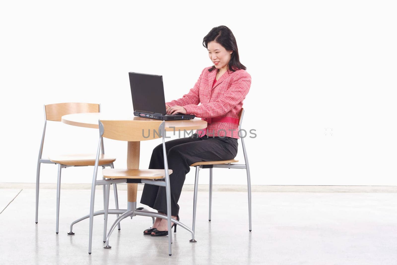 Side profile of a businesswoman using a laptop