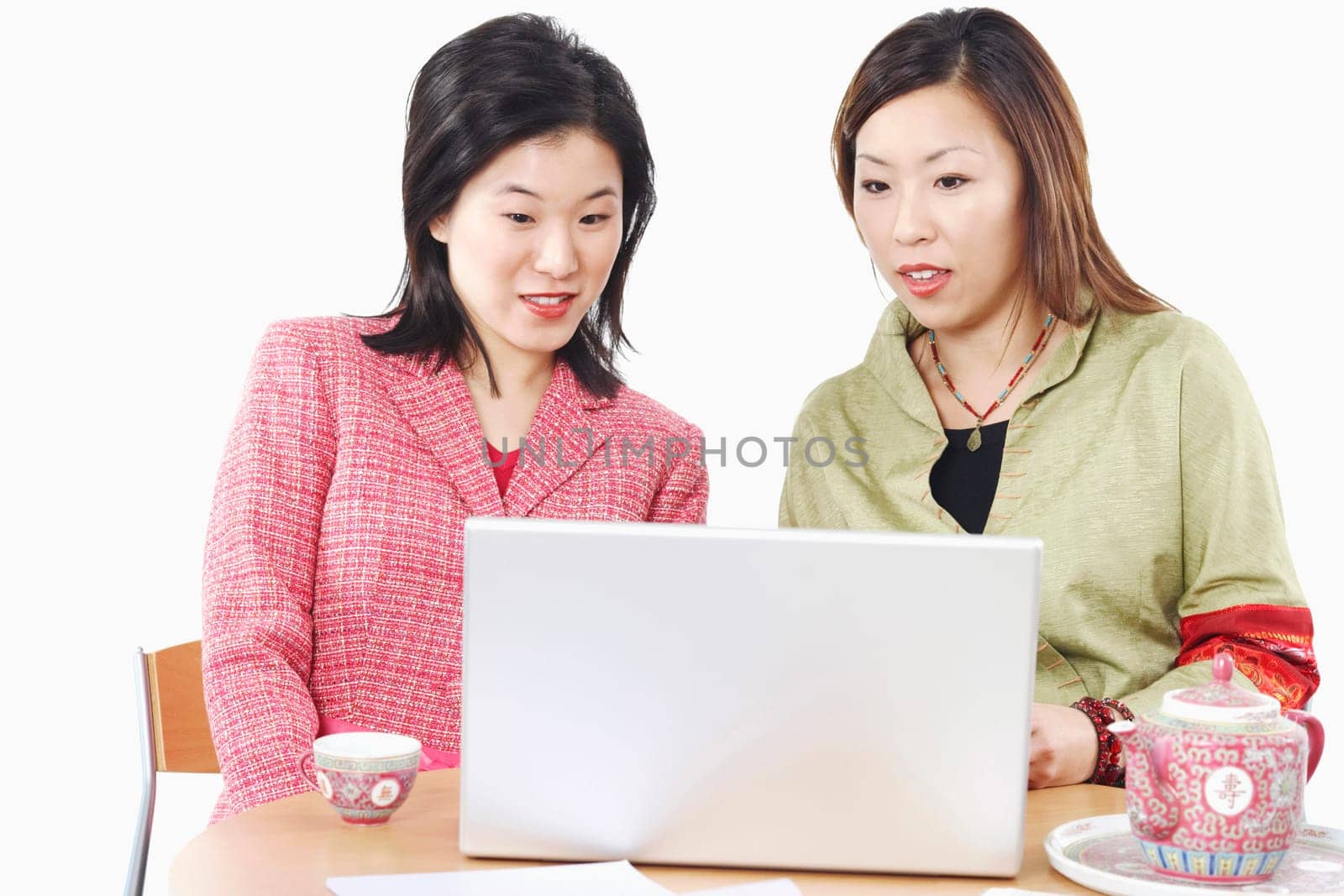 Close-up of two businesswomen using a laptop