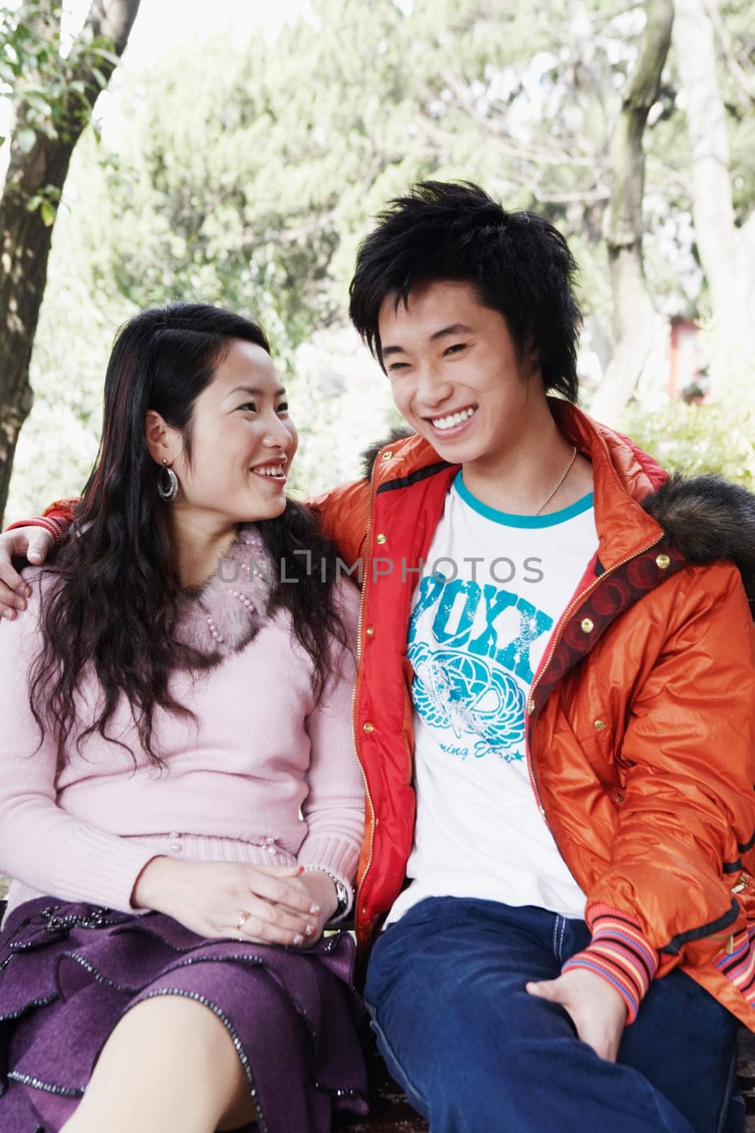 Teenage boy sitting with a young woman