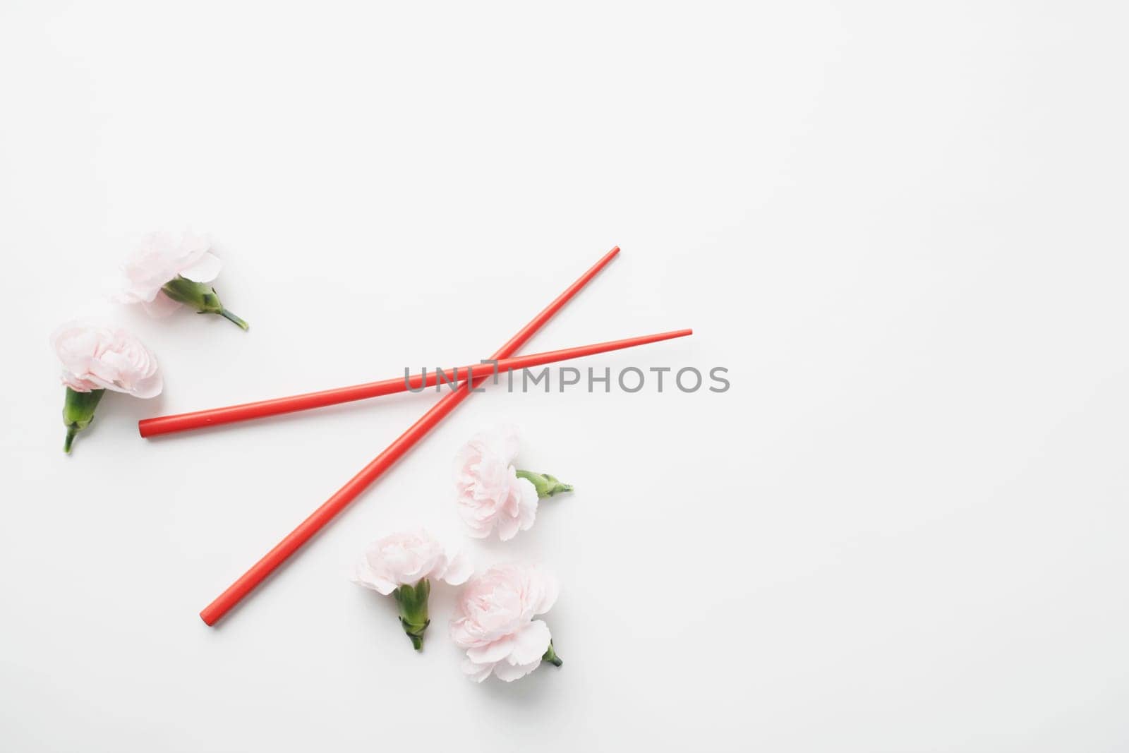 High angle view of a pair of chopsticks and flowers