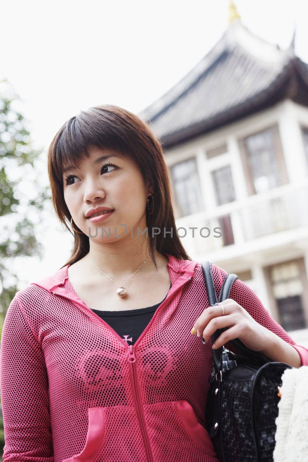 Low angle view of a young woman looking away thinking