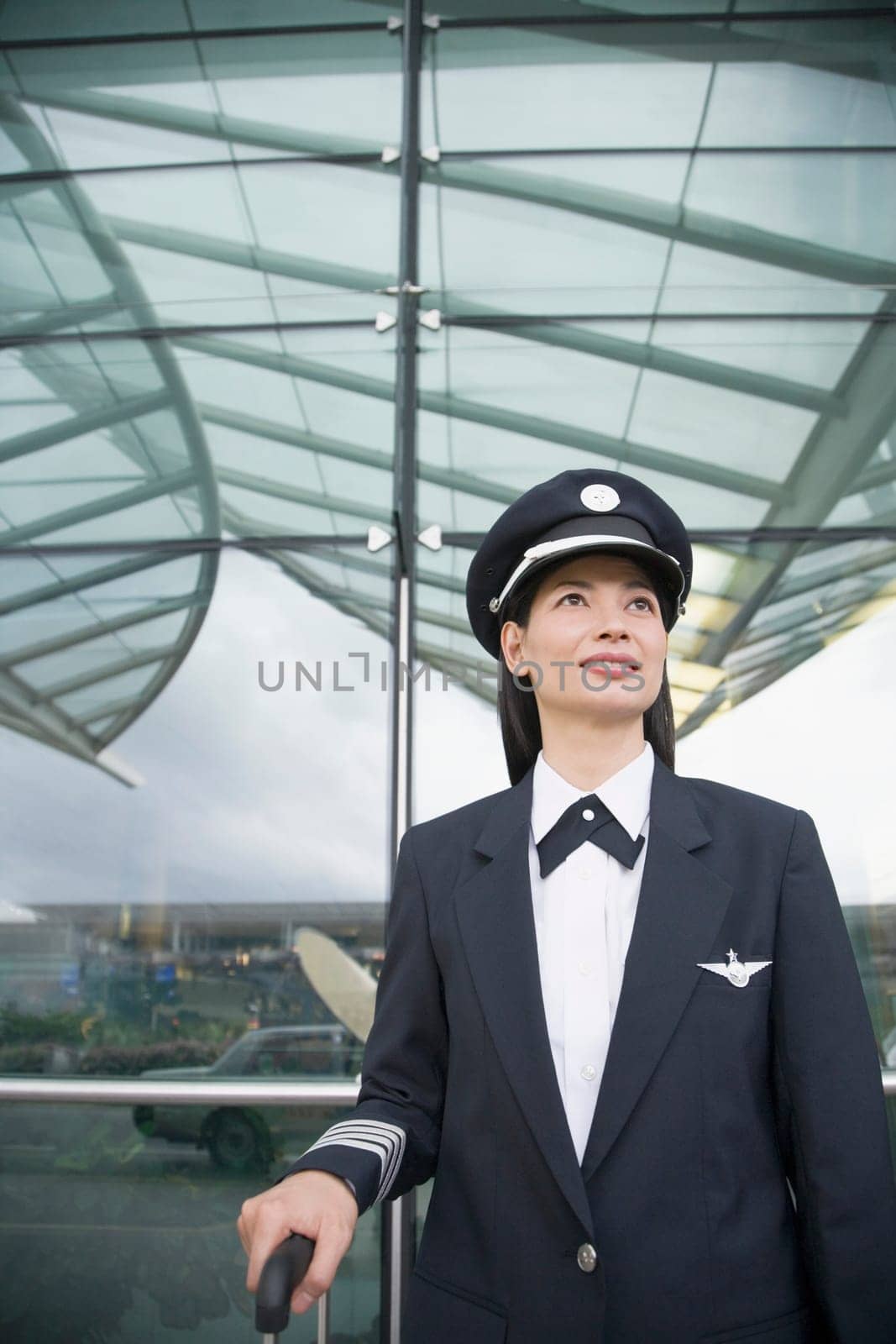 Close-up of a female pilot standing at an airport