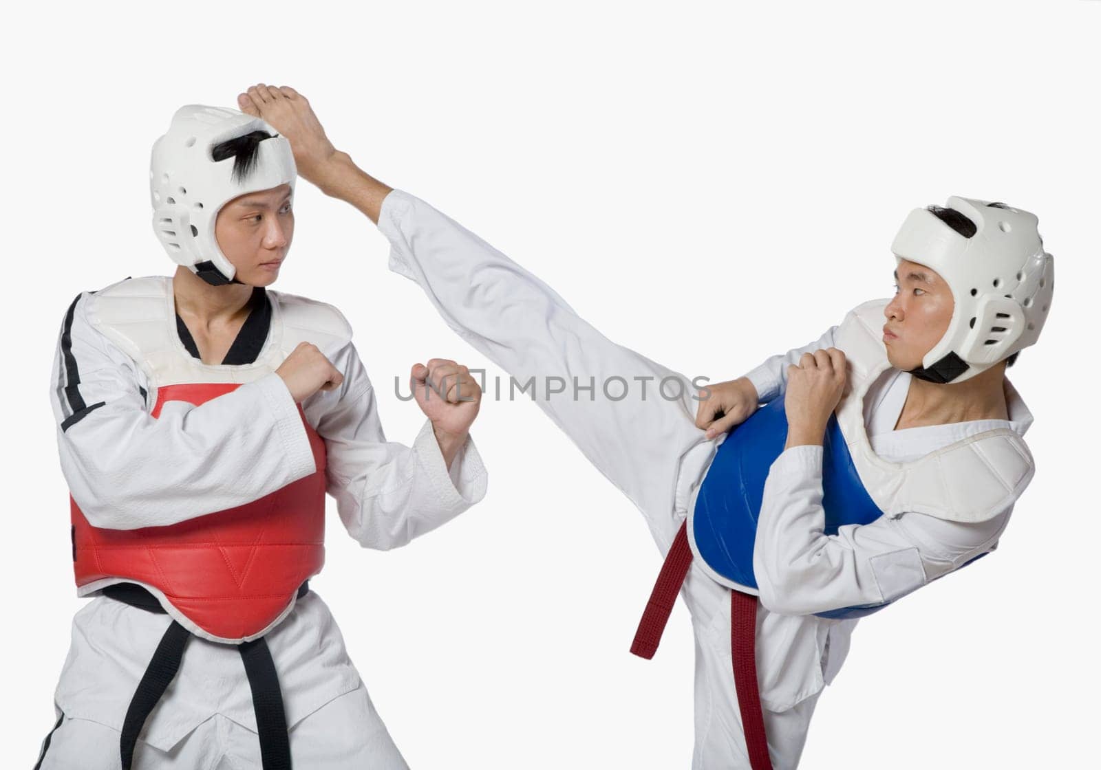 Close-up of a mid adult man practicing kickboxing with a young man