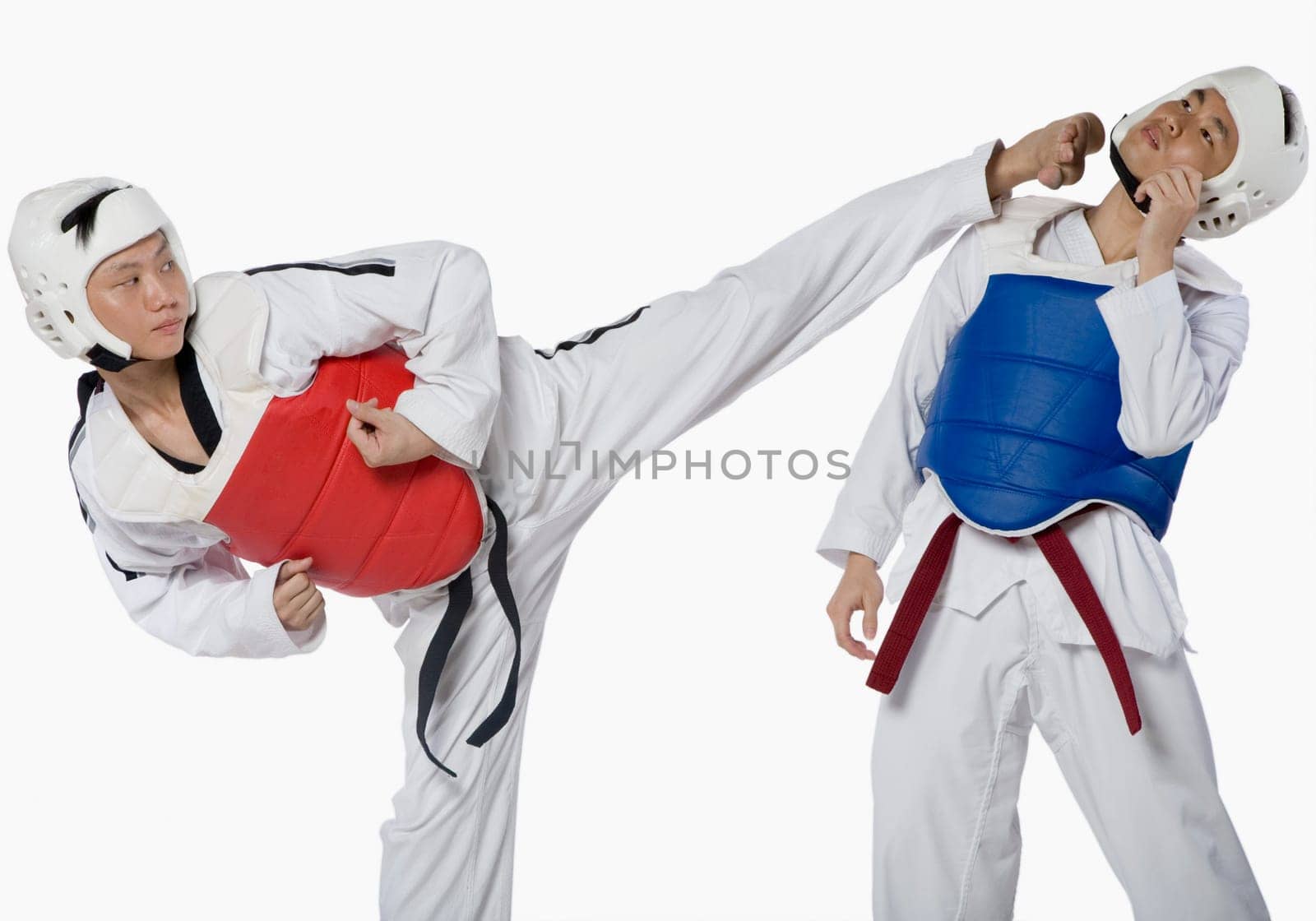 Close-up of a mid adult man practicing kickboxing with a young man