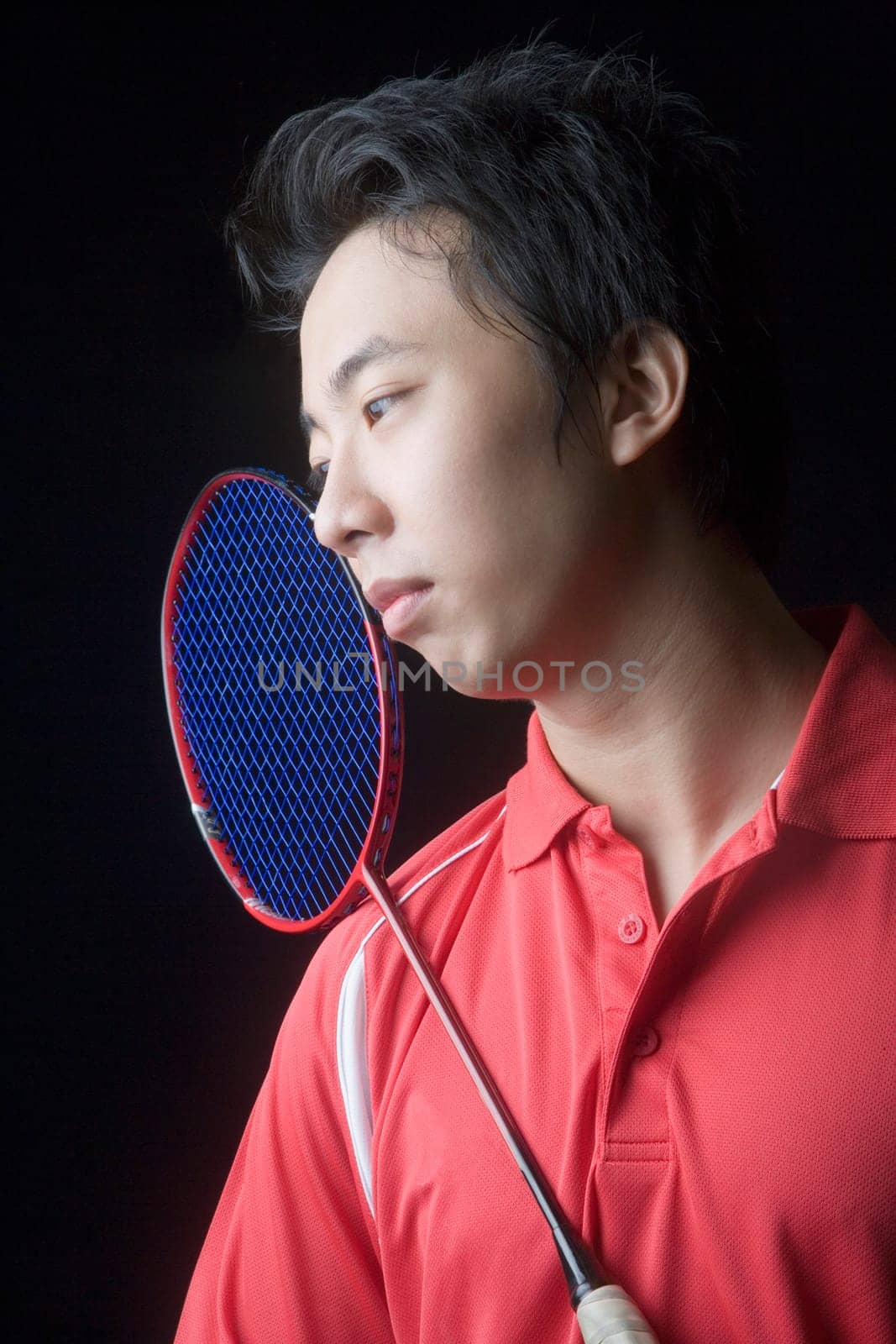Close-up of a young man with a badminton racket