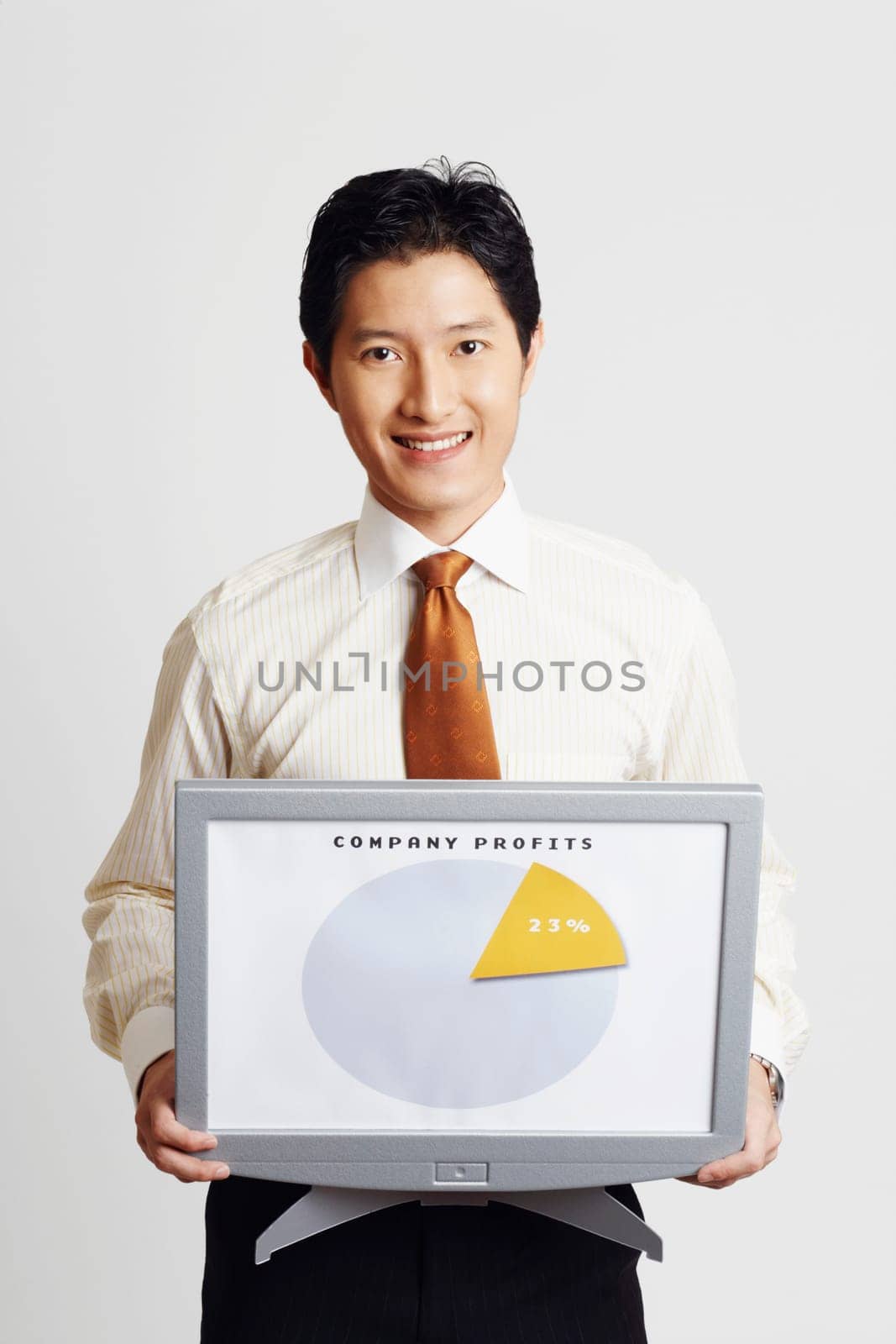 Portrait of a businessman holding a model of a computer monitor and showing a progress report